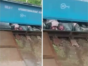Шокирующее видео Нетрезвая семейная пара чудом избежала травм на рельсах под товарным поездом видео